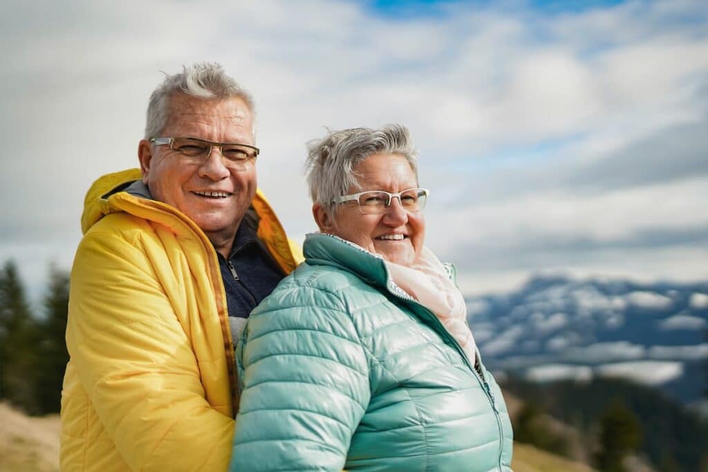 Baxter Senior Living | Couple Smiling With Mountains In The Background