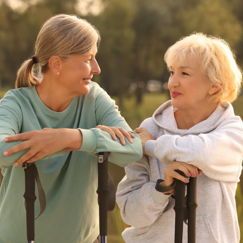 Baxter Senior Living | Two senior women with Nordic walking poles outdoors