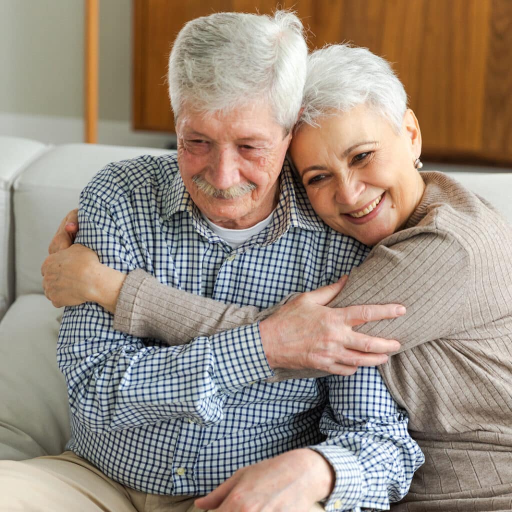 Baxter Senior Living | Senior adult couple hugging at home